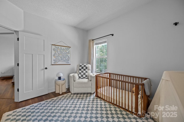 3801 Rosedown Dr, Matthews, NC 28105 - bedroom with wood finished floors, a crib, and a textured ceiling