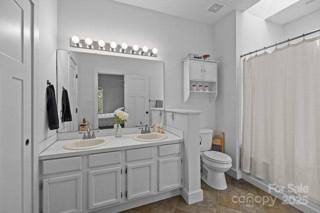 3801 Rosedown Dr, Matthews, NC 28105 - full bathroom with double vanity, toilet, and shower / bath combo