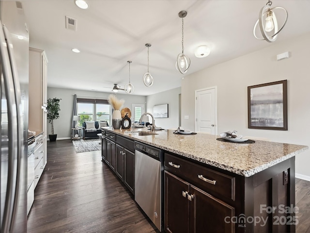 2017 New Hope Branch Way, Belmont, NC 28012 - kitchen featuring appliances with stainless steel finishes, a sink, dark wood finished floors, light stone counters, and baseboards