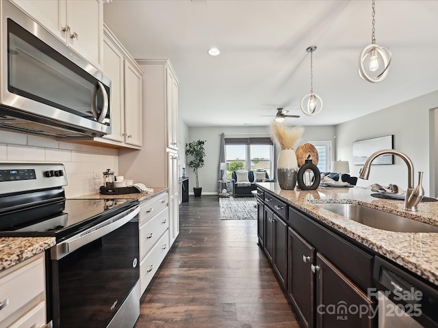 2017 New Hope Branch Way, Belmont, NC 28012 - kitchen featuring appliances with stainless steel finishes, a sink, dark wood finished floors, a ceiling fan, and decorative backsplash