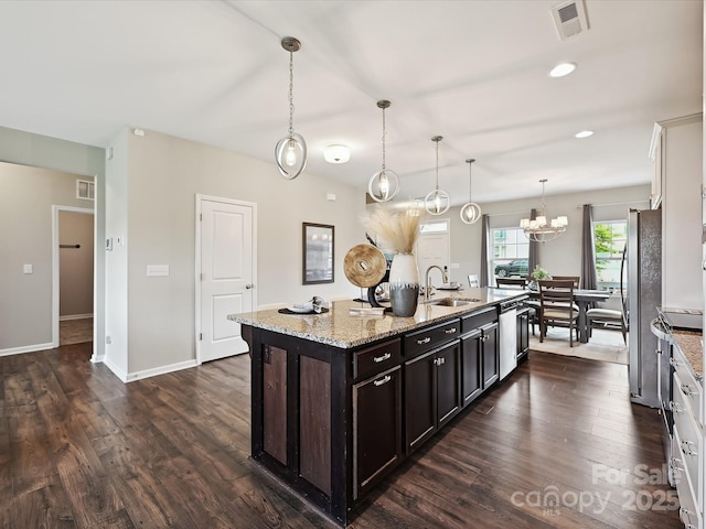 2017 New Hope Branch Way, Belmont, NC 28012 - kitchen featuring a sink, appliances with stainless steel finishes, a kitchen island with sink, dark wood-type flooring, and light stone countertops