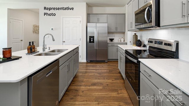 925 Two Brothers Ln, York, SC 29745 - kitchen with stainless steel appliances, gray cabinets, a sink, and dark wood-style flooring