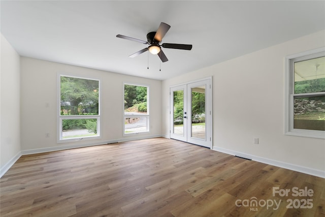 94 Camp Branch Rd, Black Mountain, NC 28711 - empty room with plenty of natural light, french doors, wood finished floors, and a ceiling fan