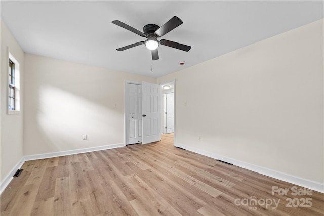 94 Camp Branch Rd, Black Mountain, NC 28711 - unfurnished bedroom with light wood-type flooring, a closet, and a ceiling fan