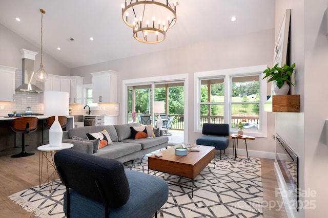 9 Robey Dr, Fletcher, NC 28732 - living area with light wood-style floors, recessed lighting, high vaulted ceiling, and a chandelier