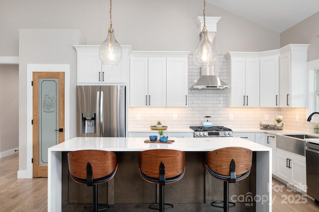 9 Robey Dr, Fletcher, NC 28732 - kitchen with stainless steel appliances, a kitchen island, vaulted ceiling, light countertops, and decorative backsplash