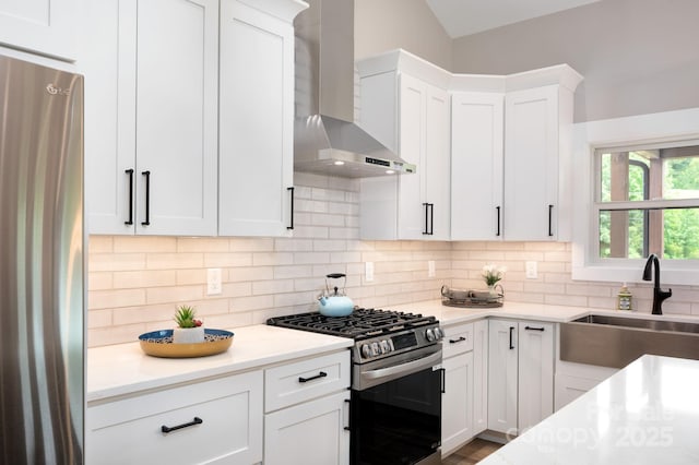 9 Robey Dr, Fletcher, NC 28732 - kitchen with appliances with stainless steel finishes, wall chimney range hood, backsplash, white cabinetry, and vaulted ceiling