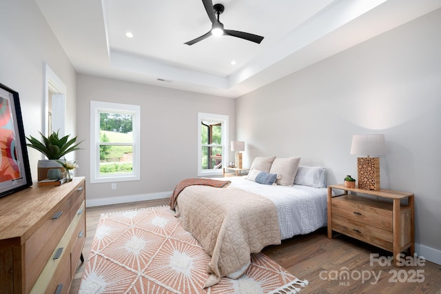 9 Robey Dr, Fletcher, NC 28732 - bedroom with wood finished floors, a tray ceiling, recessed lighting, and a ceiling fan