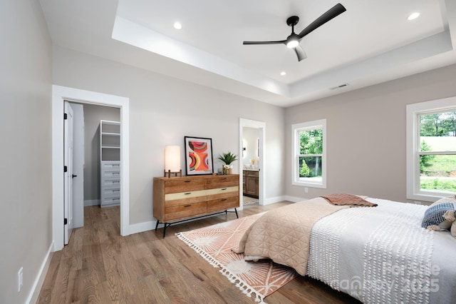 9 Robey Dr, Fletcher, NC 28732 - bedroom featuring a tray ceiling, a spacious closet, wood finished floors, recessed lighting, and ensuite bathroom