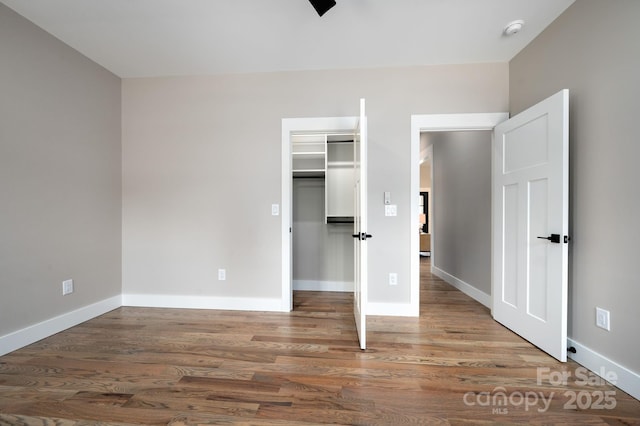 9 Robey Dr, Fletcher, NC 28732 - unfurnished bedroom featuring wood finished floors, a closet, and a walk in closet