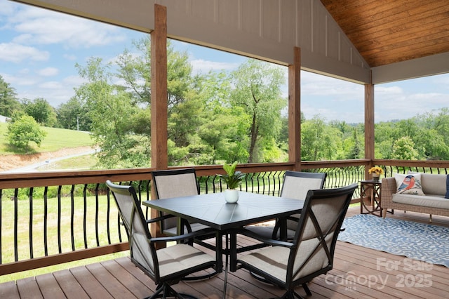 9 Robey Dr, Fletcher, NC 28732 - deck featuring outdoor dining area, view of scattered trees, and a lawn