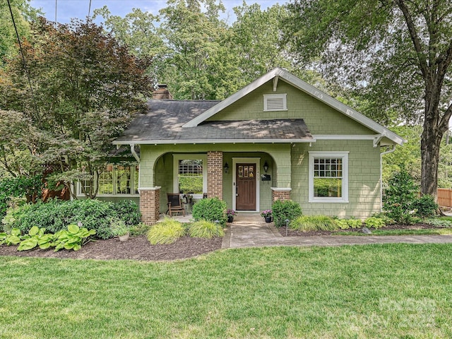 3459 Selwyn Ave, Charlotte, NC 28209 - view of front of home featuring covered porch, a front lawn, a chimney, and roof with shingles