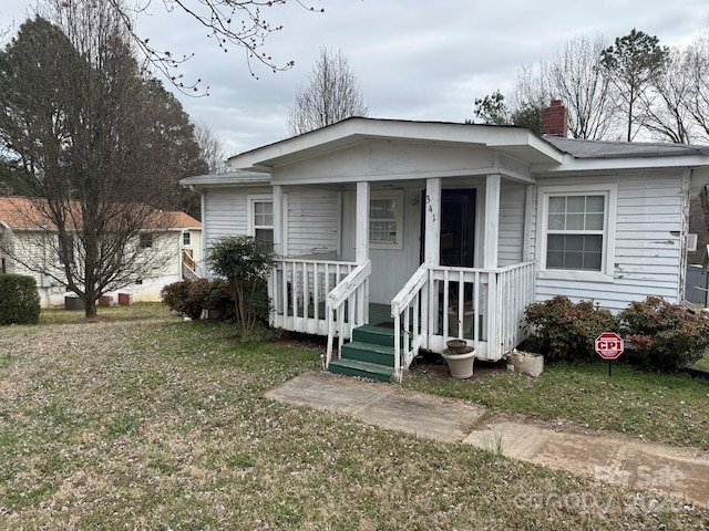 341 Talley St, Troutman, NC 28166 - view of front of home featuring a chimney, covered porch, and a front lawn