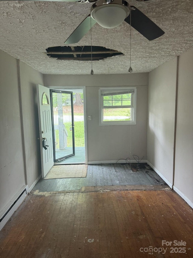 341 Talley St, Troutman, NC 28166 - foyer featuring wood-type flooring, baseboard heating, and baseboards