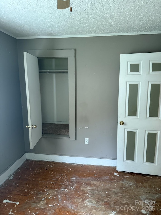 341 Talley St, Troutman, NC 28166 - unfurnished bedroom with a textured ceiling, a closet, crown molding, and baseboards