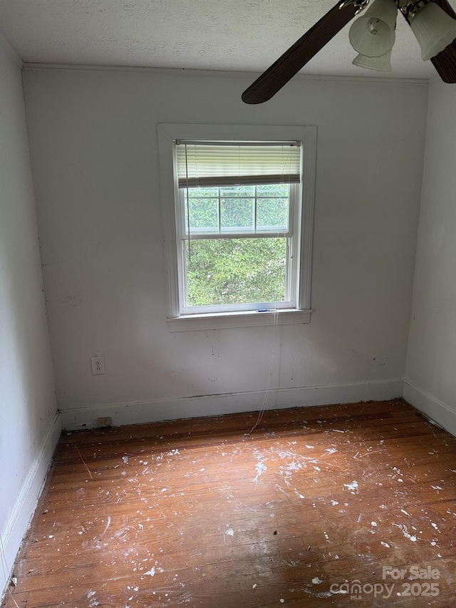341 Talley St, Troutman, NC 28166 - unfurnished room with wood finished floors, baseboards, and a ceiling fan