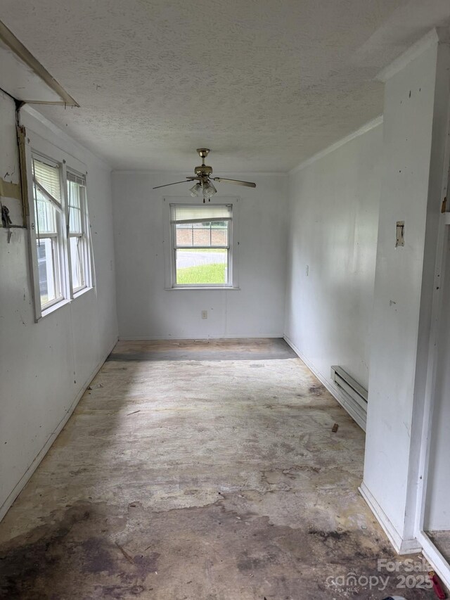 341 Talley St, Troutman, NC 28166 - empty room featuring a textured ceiling, a ceiling fan, and a baseboard radiator