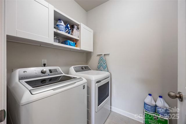 5088 Watersail Way, Clover, SC 29710 - washroom featuring separate washer and dryer, cabinet space, baseboards, and light tile patterned floors