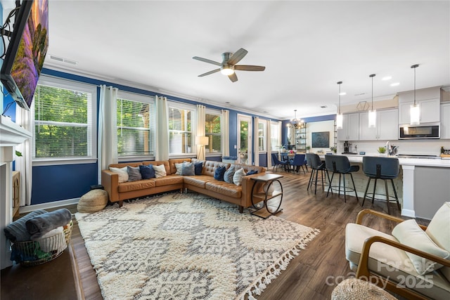5088 Watersail Way, Clover, SC 29710 - living area with ceiling fan, healthy amount of natural light, dark wood-type flooring, ornamental molding, and a chandelier