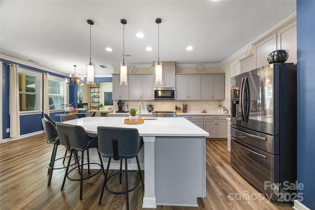 5088 Watersail Way, Clover, SC 29710 - kitchen with appliances with stainless steel finishes, gray cabinets, crown molding, a kitchen bar, and dark wood-style flooring