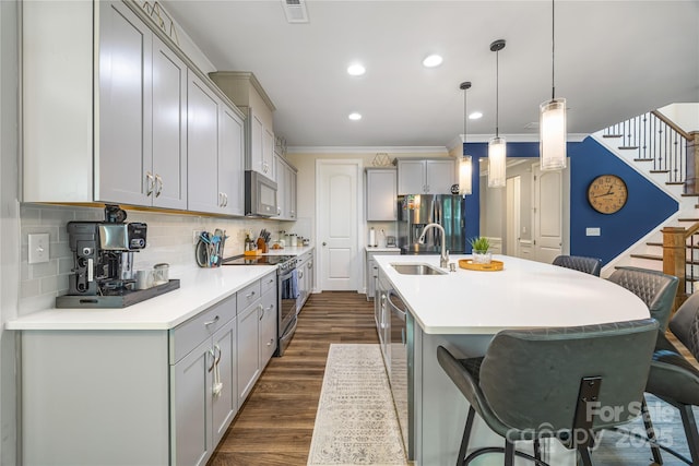 5088 Watersail Way, Clover, SC 29710 - kitchen with appliances with stainless steel finishes, a sink, gray cabinets, a kitchen breakfast bar, and crown molding