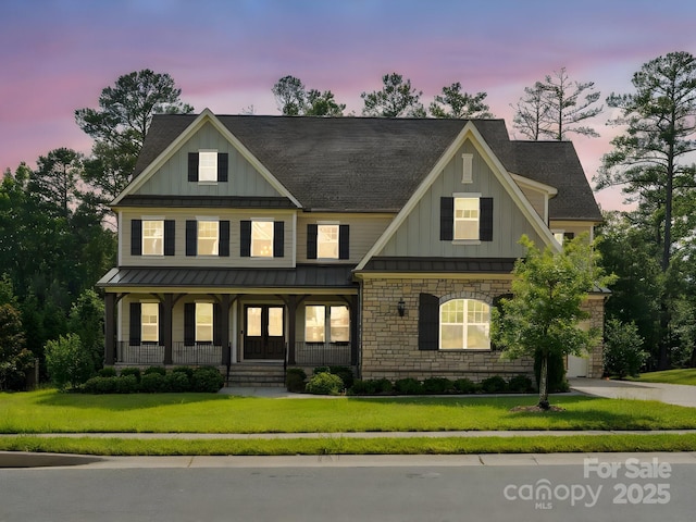 1008 Ladera Dr, Marvin, NC 28173 - craftsman house with board and batten siding, a porch, a standing seam roof, and a yard