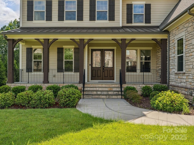 1008 Ladera Dr, Marvin, NC 28173 - view of exterior entry with a standing seam roof, covered porch, a lawn, and a metal roof