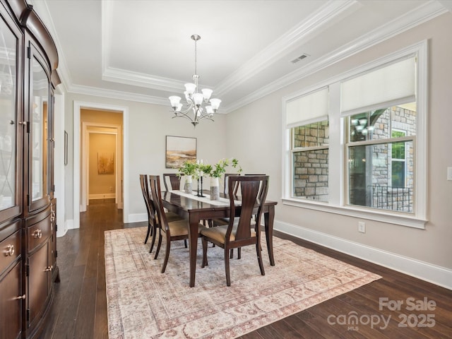 1008 Ladera Dr, Marvin, NC 28173 - dining room featuring a chandelier, a raised ceiling, dark wood finished floors, and ornamental molding