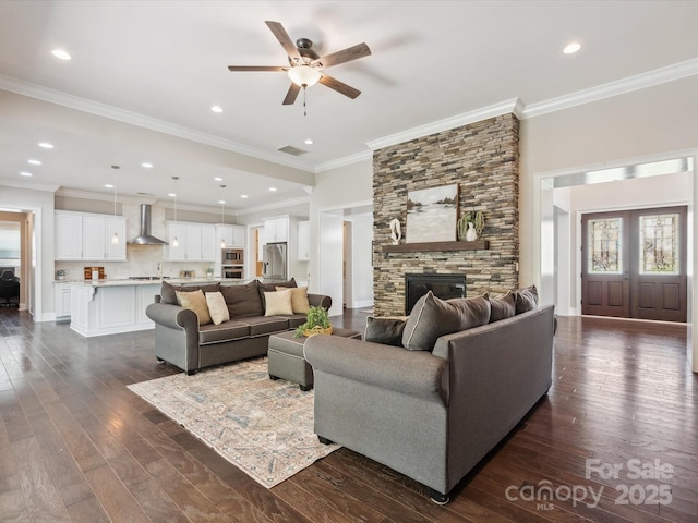 1008 Ladera Dr, Marvin, NC 28173 - living room featuring a ceiling fan, dark wood-type flooring, a fireplace, crown molding, and recessed lighting