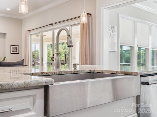 1008 Ladera Dr, Marvin, NC 28173 - kitchen featuring ornamental molding, light stone counters, decorative light fixtures, white cabinets, and stainless steel dishwasher