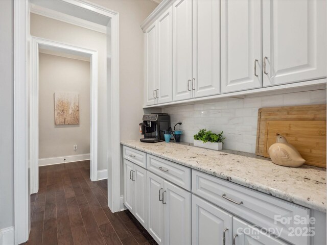 1008 Ladera Dr, Marvin, NC 28173 - kitchen with white cabinets, decorative backsplash, dark wood-style flooring, and light stone counters