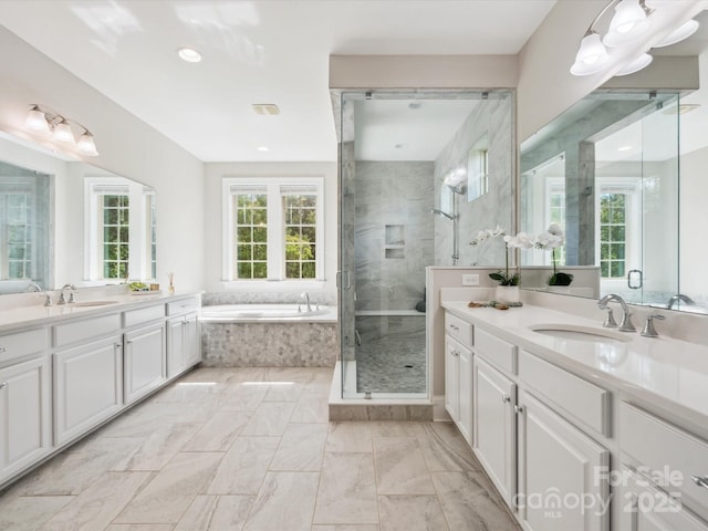 1008 Ladera Dr, Marvin, NC 28173 - bathroom featuring two vanities, a shower stall, a bath, marble finish flooring, and recessed lighting