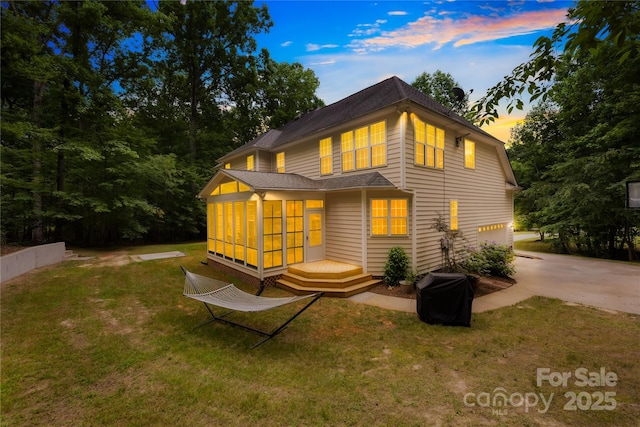 763 Evans Manor Dr, Weddington, NC 28104 - back of house with driveway, a sunroom, a lawn, an attached garage, and a deck