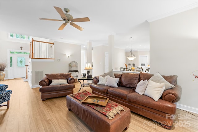 763 Evans Manor Dr, Weddington, NC 28104 - living room featuring light wood-type flooring, crown molding, a ceiling fan, and baseboards