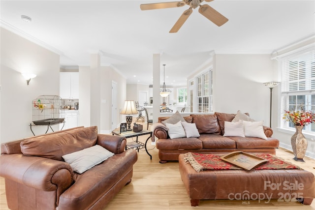 763 Evans Manor Dr, Weddington, NC 28104 - living room featuring ornamental molding, light wood-style flooring, a ceiling fan, and baseboards