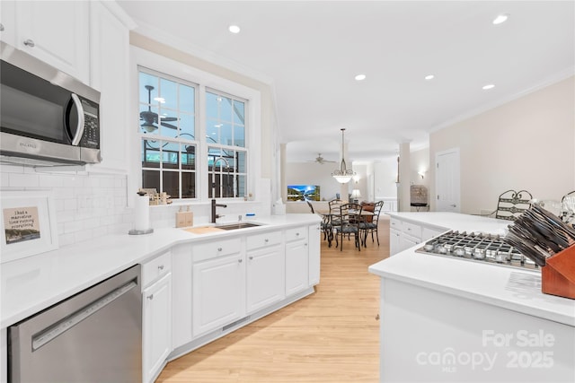 763 Evans Manor Dr, Weddington, NC 28104 - kitchen with appliances with stainless steel finishes, tasteful backsplash, light wood-style flooring, a sink, and recessed lighting