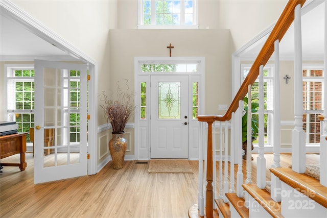 763 Evans Manor Dr, Weddington, NC 28104 - entrance foyer with light wood finished floors, a high ceiling, stairway, and crown molding