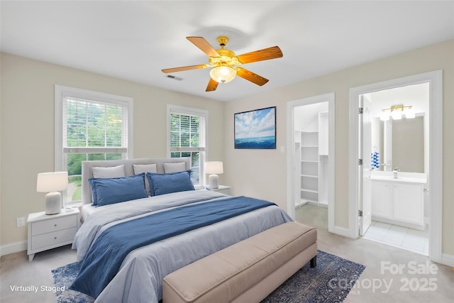 763 Evans Manor Dr, Weddington, NC 28104 - bedroom with light colored carpet, baseboards, a walk in closet, connected bathroom, and a ceiling fan