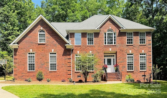 763 Evans Manor Dr, Weddington, NC 28104 - view of front facade with a front yard, brick siding, and view of wooded area