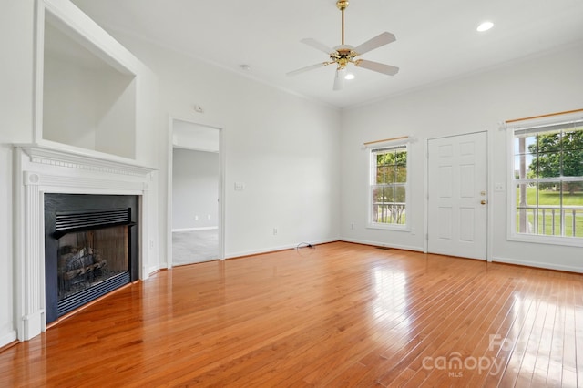 924 Secrest Hill Dr, Monroe, NC 28110 - unfurnished living room with plenty of natural light, wood finished floors, a fireplace, a ceiling fan, and recessed lighting