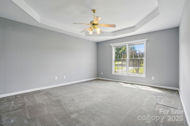 924 Secrest Hill Dr, Monroe, NC 28110 - carpeted empty room featuring a raised ceiling, ceiling fan, and baseboards