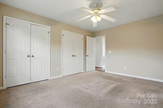 924 Secrest Hill Dr, Monroe, NC 28110 - unfurnished bedroom with two closets, carpet flooring, baseboards, and ceiling fan