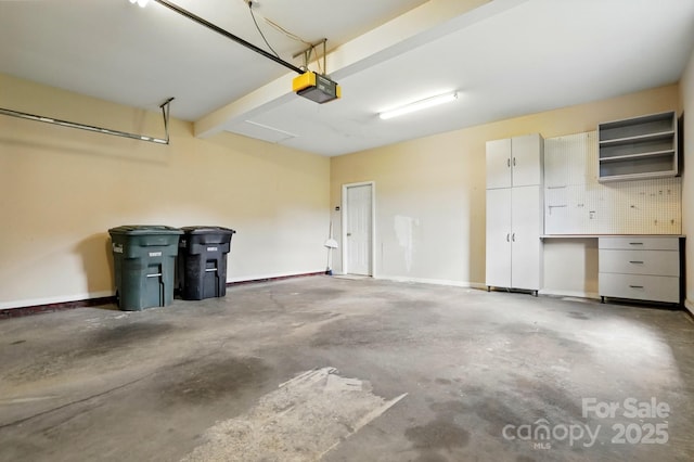 924 Secrest Hill Dr, Monroe, NC 28110 - garage featuring a garage door opener and baseboards
