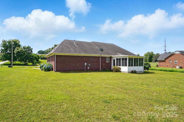 924 Secrest Hill Dr, Monroe, NC 28110 - rear view of property featuring a sunroom, a lawn, and brick siding