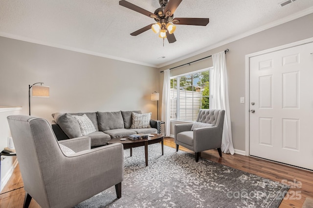 4124 Melrose Club Dr, Matthews, NC 28105 - living room featuring ceiling fan, a textured ceiling, wood finished floors, crown molding, and baseboards