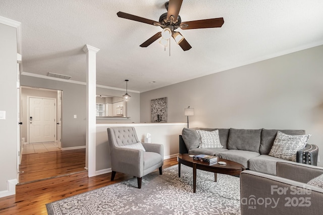 4124 Melrose Club Dr, Matthews, NC 28105 - living room featuring wood finished floors, ceiling fan, baseboards, a textured ceiling, and ornamental molding