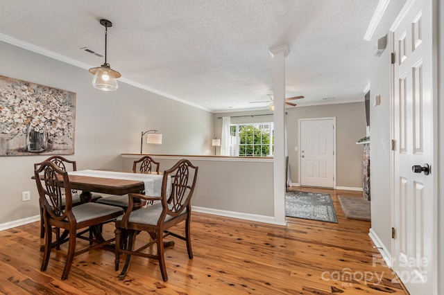 4124 Melrose Club Dr, Matthews, NC 28105 - dining area with a textured ceiling, crown molding, wood finished floors, a ceiling fan, and baseboards