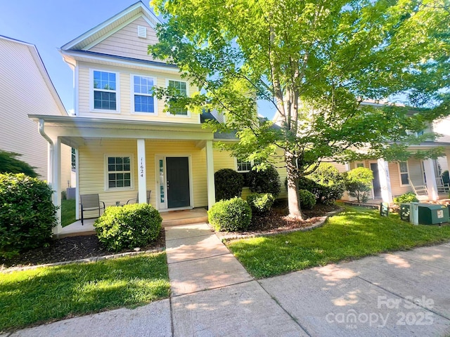 11624 Truan Ln, Cornelius, NC 28031 - view of front of house with covered porch and a front yard