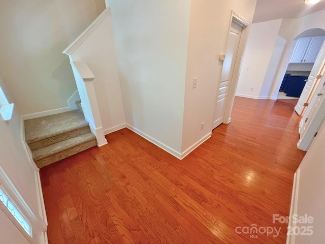 11624 Truan Ln, Cornelius, NC 28031 - stairway with arched walkways, wood finished floors, and baseboards