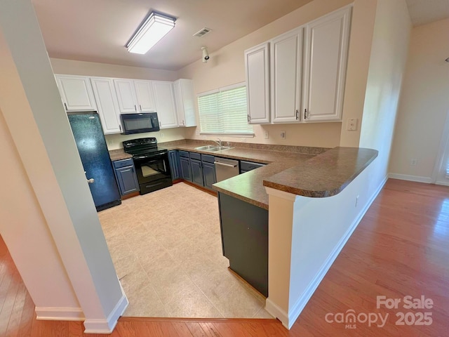 11624 Truan Ln, Cornelius, NC 28031 - kitchen featuring black appliances, white cabinetry, a sink, and a peninsula